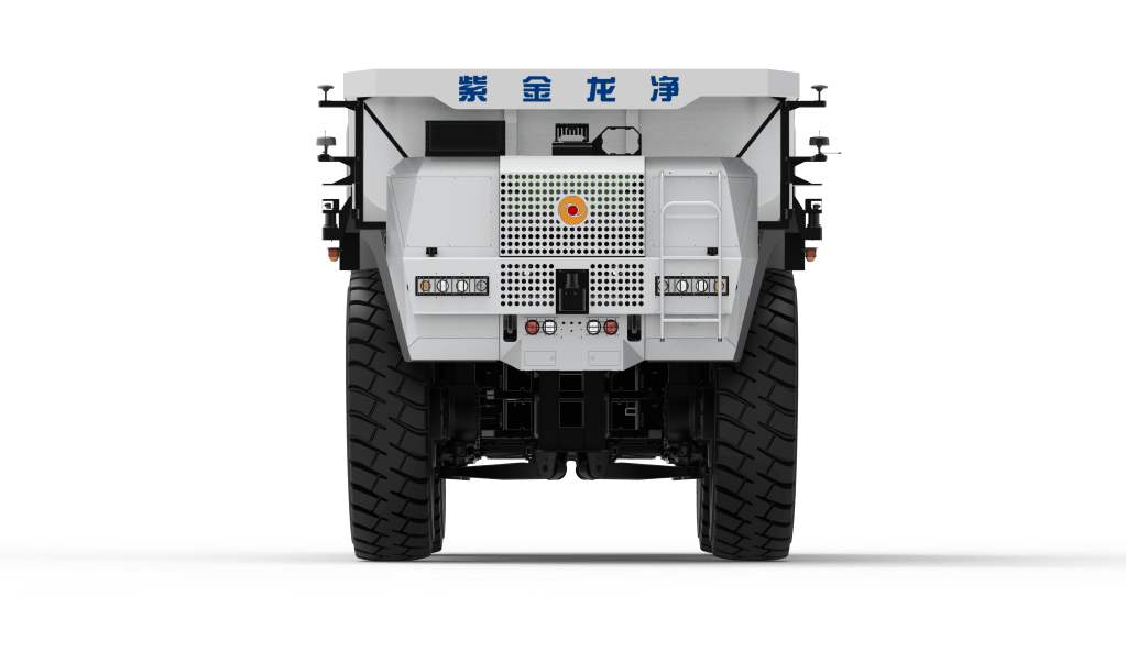 A large industrial vehicle viewed from the rear, featuring prominent tires and a white body with a blue insignia on top.