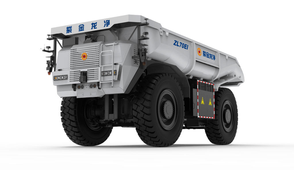 A rear view of a large mining dump truck with oversized tires and a white body displaying Chinese characters and safety symbols.
